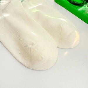 Close-up of premium combed cotton knit texture on white breathable low-cut socks