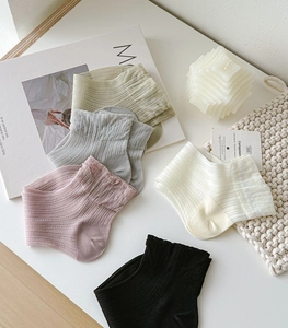 Detailed flat lay of breathable low-cut cotton socks in pastel colors for women