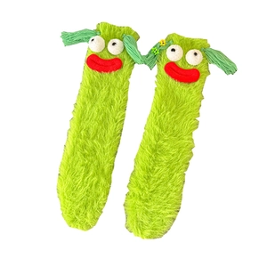 Funny green fuzzy monster socks with large eyes and thick red lips for cozy warmth