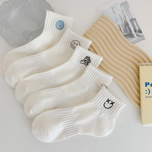 Five pairs of white cotton mid-calf socks with diverse embroidered smiley face patterns