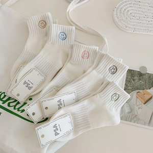 Five pairs of white cotton sports socks with colorful embroidered smiley faces for women
