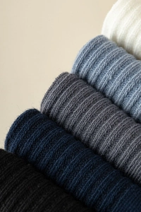 Detail of ribbed knit cotton blend socks showing vertical texture in five colors
