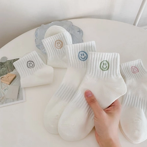 Five-pack of white cotton athletic socks featuring colorful embroidered smiley faces