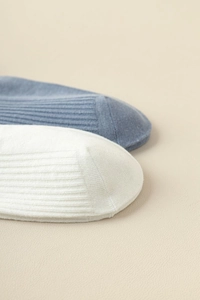 Detailed close-up of ribbed knit cotton socks showing premium reinforced toe seam quality