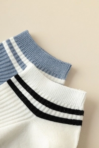 Detailed close-up of ribbed cuffs on cotton boat socks with sporty double stripe patterns