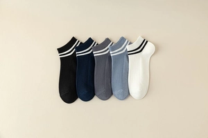 Detail of five pairs of ribbed low-cut ankle socks with sporty stripes in assorted colors