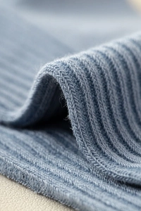 Macro shot of blue vertical ribbed knit fabric texture on premium men's boat socks