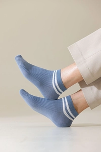Detail of blue cotton ankle socks with white stripes and vertical rib texture for men