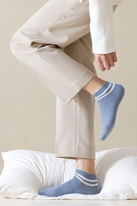 Detail of light blue low-cut cotton socks featuring white stripes and rib knit texture