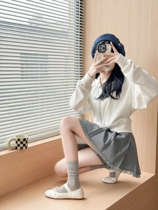 Detail of sweet ballerina style mesh socks with a bow and lace pleated skirt ensemble