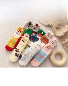Close-up of fluffy coral fleece socks with cute 3D cartoon animal characters for winter