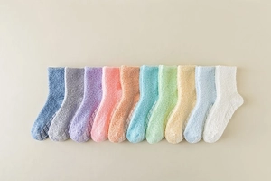 Detail of non-slip silicone grippers on warm fuzzy coral fleece socks in colorful multipack