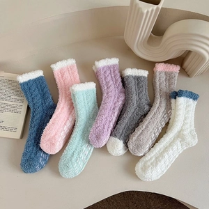 Detail of coral fleece thermal socks with anti-slip silicone grippers on the sole