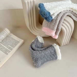 Detail of soft coral fleece socks with thick knit texture and warm fuzzy material