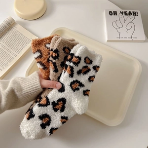 Three pairs of thick leopard print coral fleece socks in warm beige and brown tones
