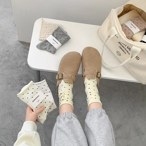 Polka dot cotton socks with khaki buckle clogs in a minimalist home aesthetic layout