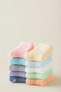 Close-up of soft coral fleece fuzzy socks in pastel colors with cozy plush texture