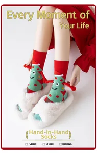 Detail of red Christmas socks with cartoon tree and 3D hand feature for hand-holding