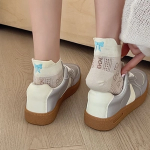Women's mesh socks with blue bow embroidery paired with gray and white platform sneakers
