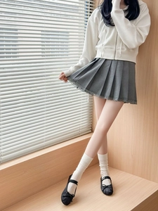 Detailed view of grey pleated skirt with lace trim for a sweet school style look