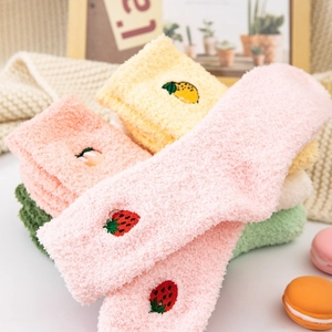 Detailed texture of thick coral fleece socks with delicate fruit embroidery patterns