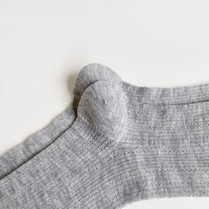 Close-up of the reinforced heel stitching on grey ribbed knit ballet style socks
