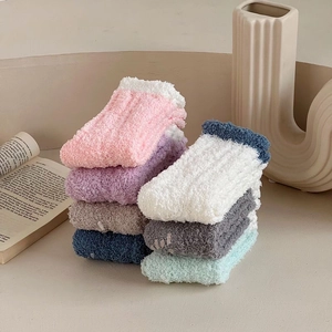 Detailed view of six thick coral fleece socks in assorted colors for winter warmth