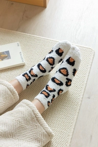Detail of soft leopard print coral fleece socks showing warm fluffy texture and comfort