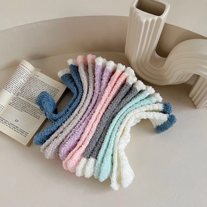 Close-up of soft coral fleece thermal socks in pastel colors for winter home comfort