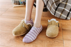 Detail of khaki suede winter slippers with warm white faux shearling lining and buckle