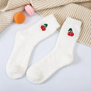 Close-up of white coral fleece socks with sweet cherry embroidery and soft texture