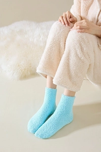 Close-up of soft light blue coral fleece socks for warm winter sleeping comfort