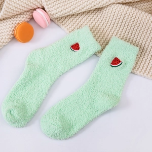 Close-up of soft coral fleece socks in light green with cute watermelon embroidery detail