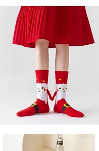 Detail of red Christmas magnetic hand-holding socks with Santa Claus cartoon patterns