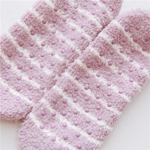 Detailed view of striped coral fleece slipper socks with anti-slip silicone grippers on sole