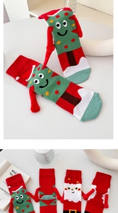 Detail of Christmas themed magnetic socks with 3D ribbon arms and festive character patterns