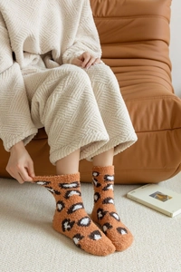 Detailed view of leopard print coral fleece socks showing thick texture and soft elasticity