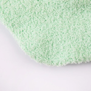 Macro view showing the soft texture of light green coral fleece socks fabric