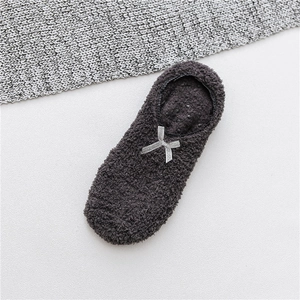 Close-up of grey coral fleece floor socks with silver sequin bow and anti-slip dots