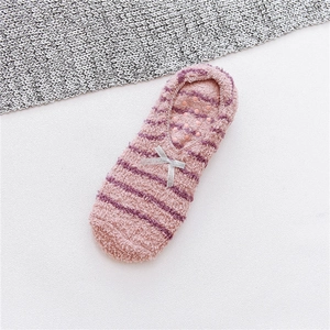 Detailed view of pink striped plush slipper socks with bow and non-slip silicone bottom
