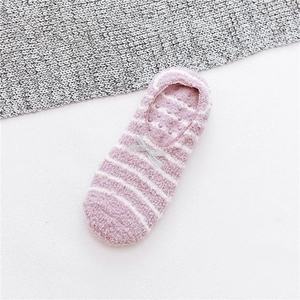 Detail view of purple striped fleece socks with bow and anti-slip silicone dots