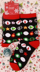 Detailed view of black and red Christmas socks with holiday patterns and brand tag