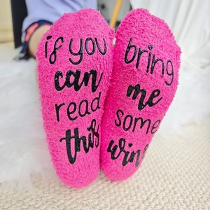 Fuzzy pink coral fleece socks with funny wine quote and non-slip rubber grip on soles