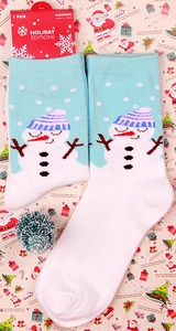 Detail of Christmas crew socks with snowman pattern and Holiday Editions gift hang tag