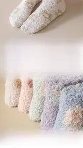 Detail of soft coral fleece socks featuring pastel colors and fluffy star patterns