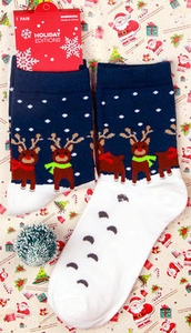 Detail of Christmas reindeer knit socks with holiday gift packaging and mini decor