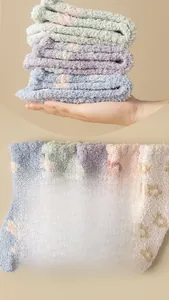 Macro detail of soft coral fleece winter socks with cute floral patterns and fluffy texture