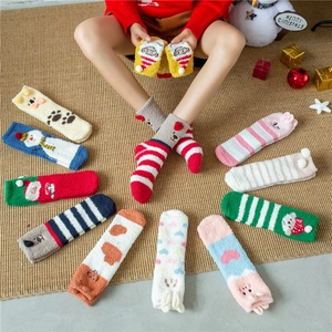 Detailed view of assorted thick coral fleece Christmas socks with 3D cartoon animal patterns