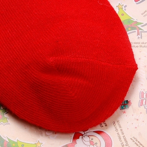 Close-up of red twill knit Christmas socks featuring thick texture and stitching details