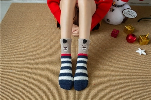 Detail of coral fleece Christmas socks featuring 3D ears and cartoon bear embroidery